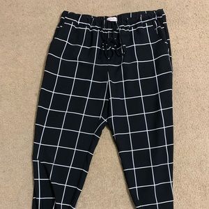 Black and white polyester pants, gathered at ankles, elastic waist, drawstring